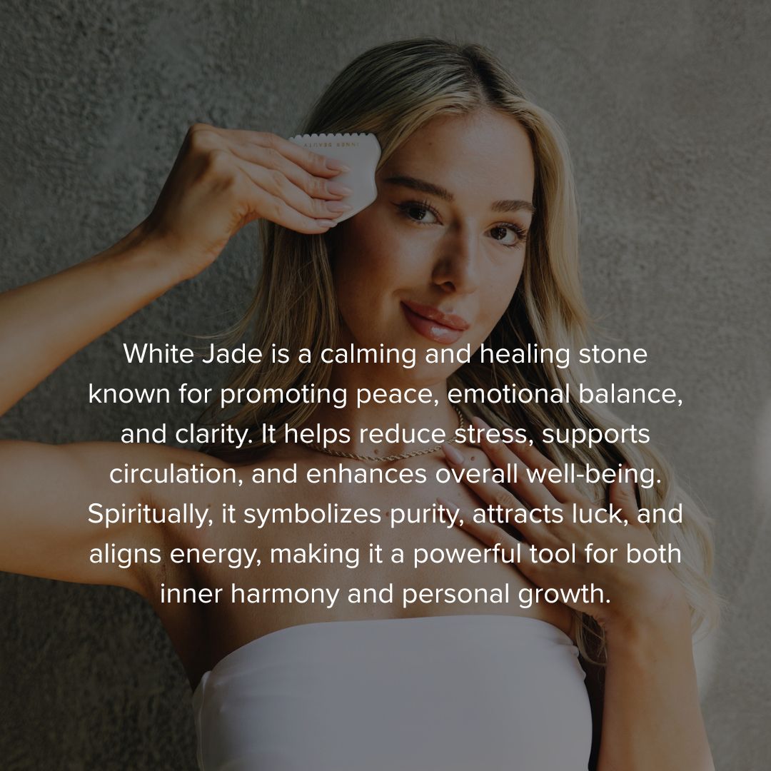 Woman holding the white jade gua sha at her temple