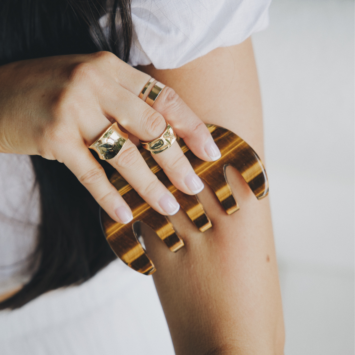 Tiger's eye gua sha comb used on the upper arm