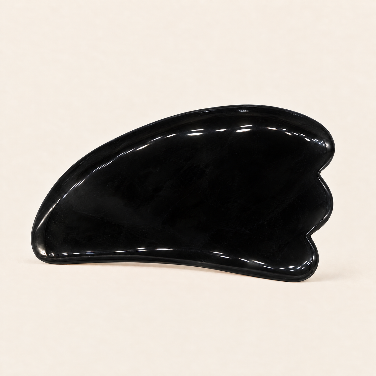 Black obsidian body gua sha tool with wavy edge
