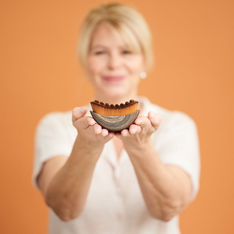 Woman holding The Lymphatic Brush in her hands